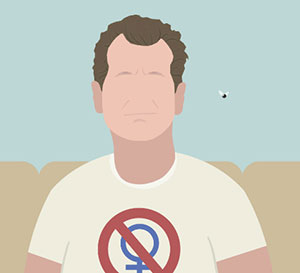 A man sitting on a couch wearing a shirt with the Feminist symbol and a red line going across it. 